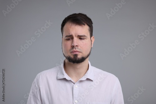 Portrait of sad man on grey background © New Africa