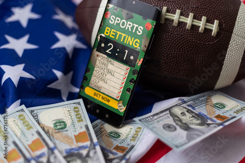 rugby ball and dollars with usa flag and smartphone bet photo