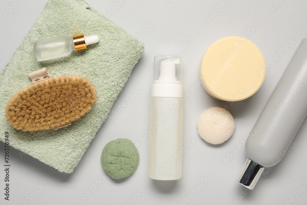 Bath accessories. Flat lay composition with personal care products on light grey background Bath accessories. Flat lay composition with personal care products on light grey background
