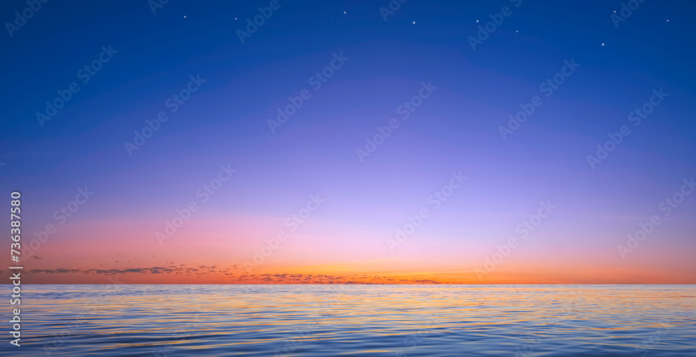 Fototapeta premium Beautiful twilight sky background over sea and stars on colorful evening sky with light reflection on water surface, Idyllic natural tranquil seascape view
