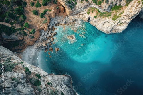 This aerial photo captures a body of water located near a cliff, showcasing the natural beauty of the landscape, Aerial vista showcasing a piercing blue sea rimmed by rocky cliffs, AI Generated