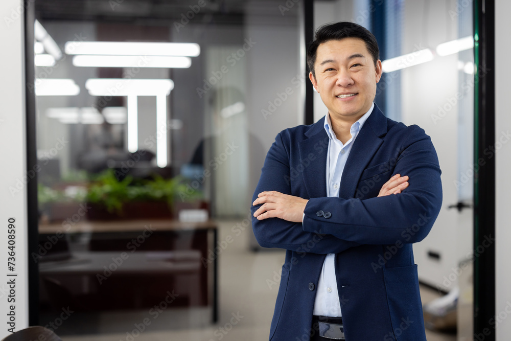 Portrait of successful asian businessman inside office at workplace, man in business suit smiling looking at camera, mature boss with crossed arms, successful financier broker. Portrait of successful asian businessman inside office at workplace, man in business suit smiling looking at camera, mature boss with crossed arms, successful financier broker.