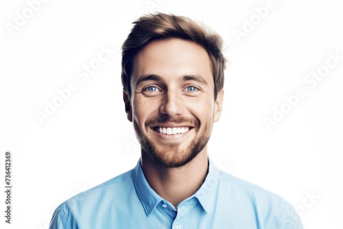 A man with a beard wearing a blue shirt smiles warmly at the camera. © pham