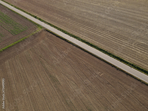 View from above of a road between farm fields in the countryside 