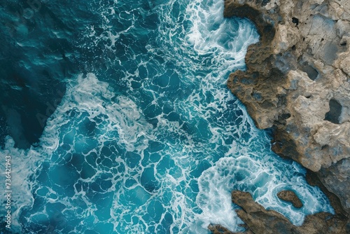 This aerial photograph showcases the expansive ocean and rugged rock formations along the coastline, Bird's eye capture of a sea painting patterns on a rocky canvas, AI Generated