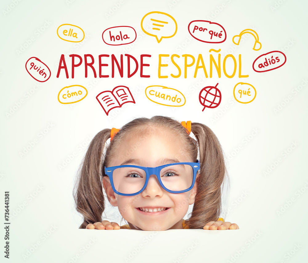 Foto de Beautiful cute little girl with eyeglasses looking at Learn