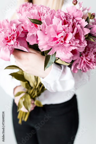 Beauty fashion closeup with women's hands holing a bouquet of peonies .Peony summer flowers bouquet. Lifestyle photo wuth flowers and a copy space. photo