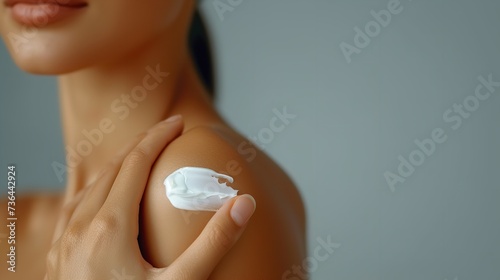 Unrecognized young woman applying lotion in her shoulder against a clean backdrop, Generative AI.