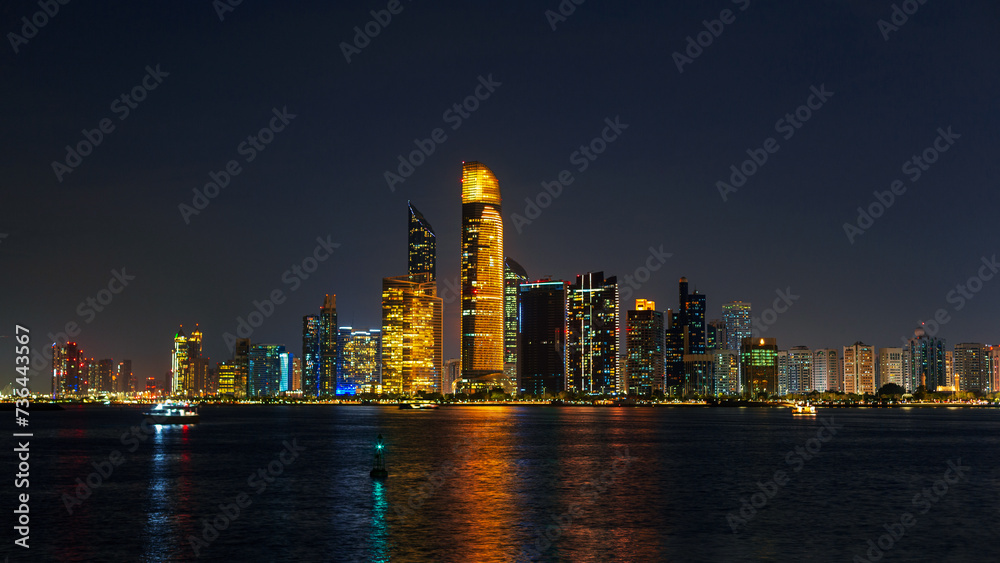 Amazing night city of Abu Dhabi. Cityscape by the water at night. Technology and the modern city Amazing night city of Abu Dhabi. Cityscape by the water at night. Technology and the modern city