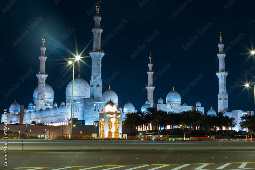Beautiful mosque with lights near the road in Abu Dhabi at night