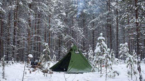 Winter camping in the Boreal Forest. Hot tent. Tipi stands in the winter forest. Tepee in the snow. Ecotourism