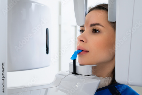 Close Up of Young Woman Receiving Panoramic Teeth X-Ray in Dentists Office. 