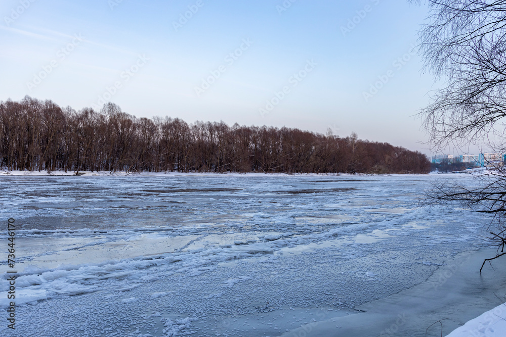 Ice floats on the water, frosty evening, cold, winter landscape with a wide river. Ice floats on the water, frosty evening, cold, winter landscape with a wide river.