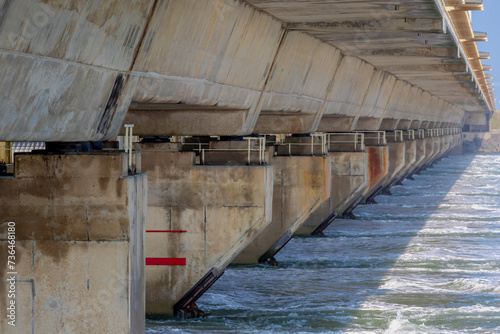 Wallpaper Mural Cement concrete dam and white wind turbine, The Delta Works is a projects to protect a large area of land around southwest from the sea, Flood protection system in Netherlands, Neeltje Jans, Zeeland. Torontodigital.ca