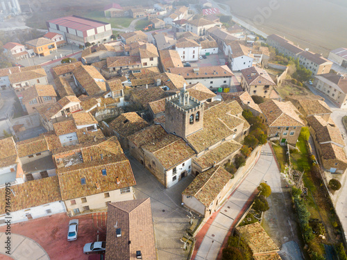 View from drone of roofs of houses in traditional village of Liedena in foggy morning, Navarre, Spain photo