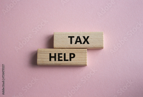 Tax Help symbol. Concept word Tax Help on wooden blocks. Beautiful pink background. Business and Tax Help concept. Copy space
