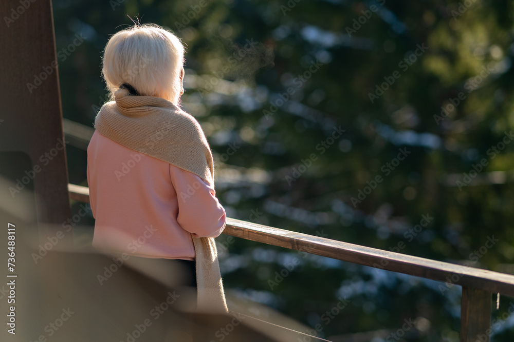 Woman on the balcony looking into the distance