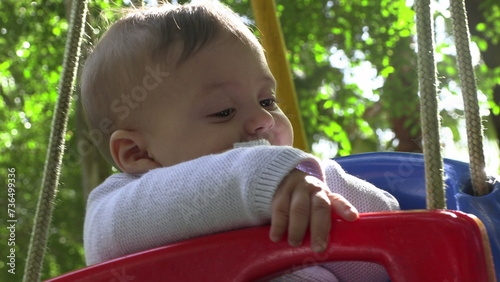 Baby boy at playground park swing © Marco