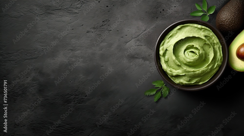 Fresh Avocado and Creamy Guacamole on Dark Surface Fresh Avocado and Creamy Guacamole on Dark Surface