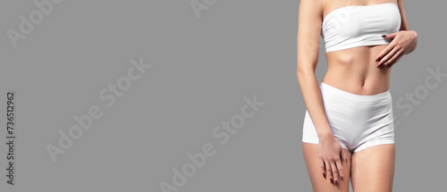 Young woman in white cotton underwear on grey background with space for text