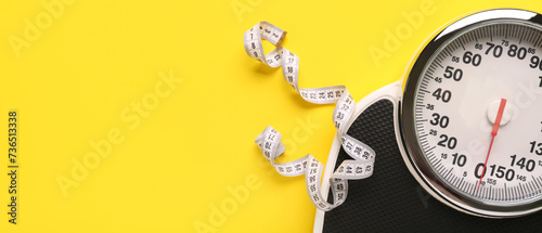 Scales and measuring tape on yellow background with space for text. Weight loss concept photo