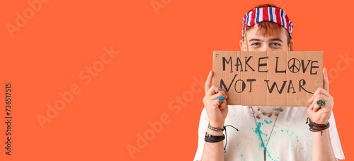 Male hippie holding placard...