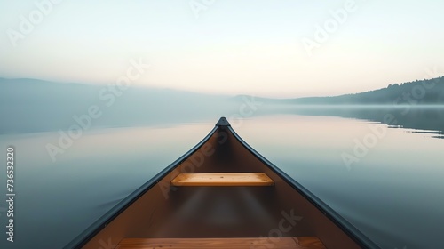 A serene journey awaits as you glide through the still  glassy waters of a tranquil lake. The ethereal glow of dawn casts a captivating mirror effect  enchanting the senses and evoking a pro