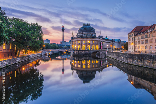 Historical buildings on Museum Island in Berlin in the morning at sunrise. River Spree with reflections. Television tower in the background of the skyline of the capital of Germany