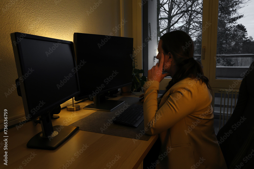 Woman working overtime in home office late at night Woman working overtime in home office late at night