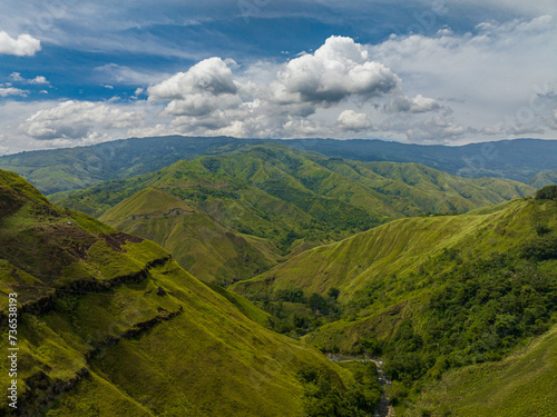 Tropical valley and green hill with river. Blue sky and clouds. Mindanao  Philippines.