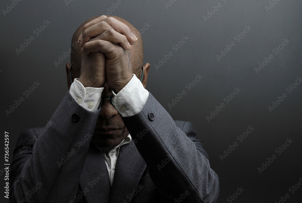 black man praying to god with black grey background with people stock image stock photo	