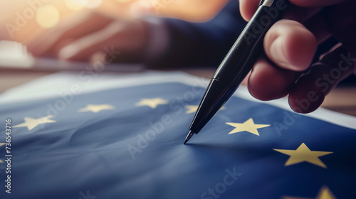 Signing a document with European Union flag, ideal for content related to EU regulations or international agreements photo