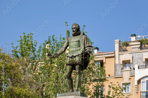 Monument to writer Miguel de Cervantes Saavedra on Plaza de las Cortes in Madrid, Spain photo