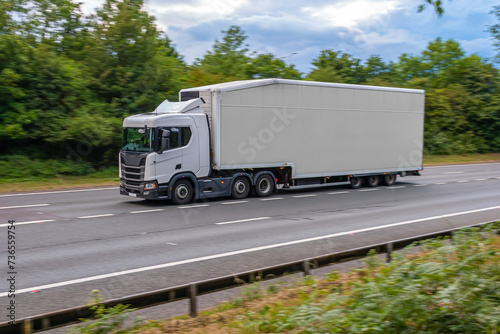 Tableau sur toile White no name double decker lorry in motion on the motorway.