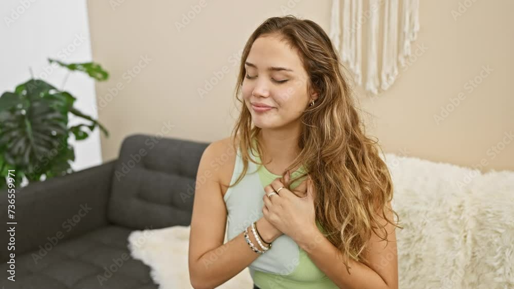 Grateful gesture, young, beautiful hispanic woman smiling, hands on chest in casual clothes, radiating health and happiness at home Grateful gesture, young, beautiful hispanic woman smiling, hands on chest in casual clothes, radiating health and happiness at home