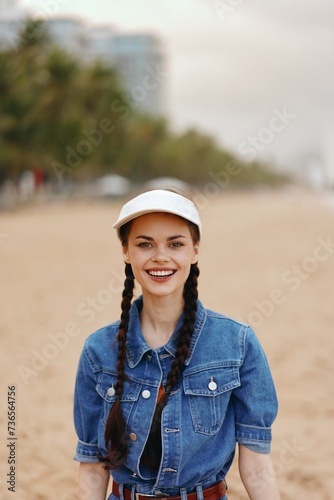 Happy Woman: Attractive Young Female with a Beautiful Smile and Casual Hat, Enjoying a Sunny Summer Vacation in a Green Park © SHOTPRIME STUDIO