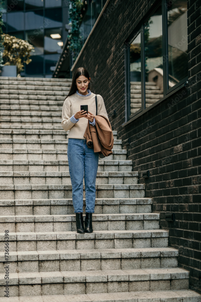 Businesswoman staying connected and productive while walking outdoors