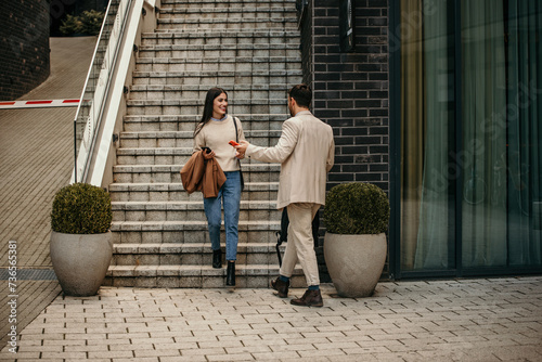 A man and a woman networking outdoors amidst bustling city streets © La Famiglia