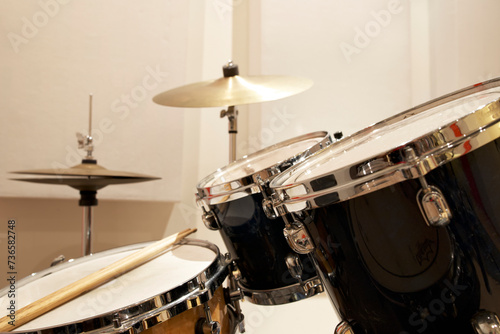 Drumset with a cymbal and Drumsticks in a rehearsal 