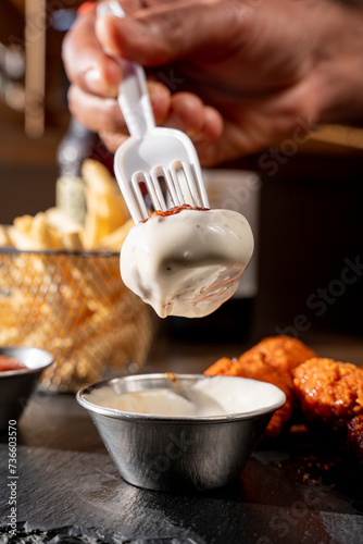 Delicious boneless with buffalo dipped in American style ranch dressing and served with fries