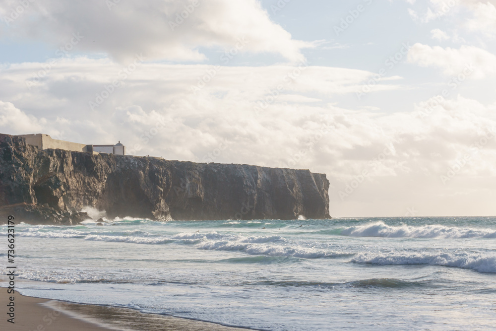 Cliff at the atlantic coast near Praia do Tonel beach with Fortaleza de Sagres, Sagres, Algarve, Portugal