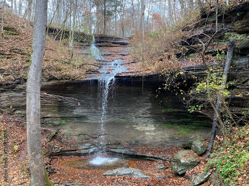 Fall Hollow Waterfall on the Natchez Trace Parkway in Tennessee. Water cascades over slate with autumn leaves. photo