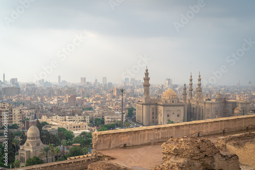 Cairo, Egypt - October 25, 2022. View of the Cairo city and the Mosque-Madrasa of Sultan Hassan from the Mosque of Muhammad Ali in the Citadel.