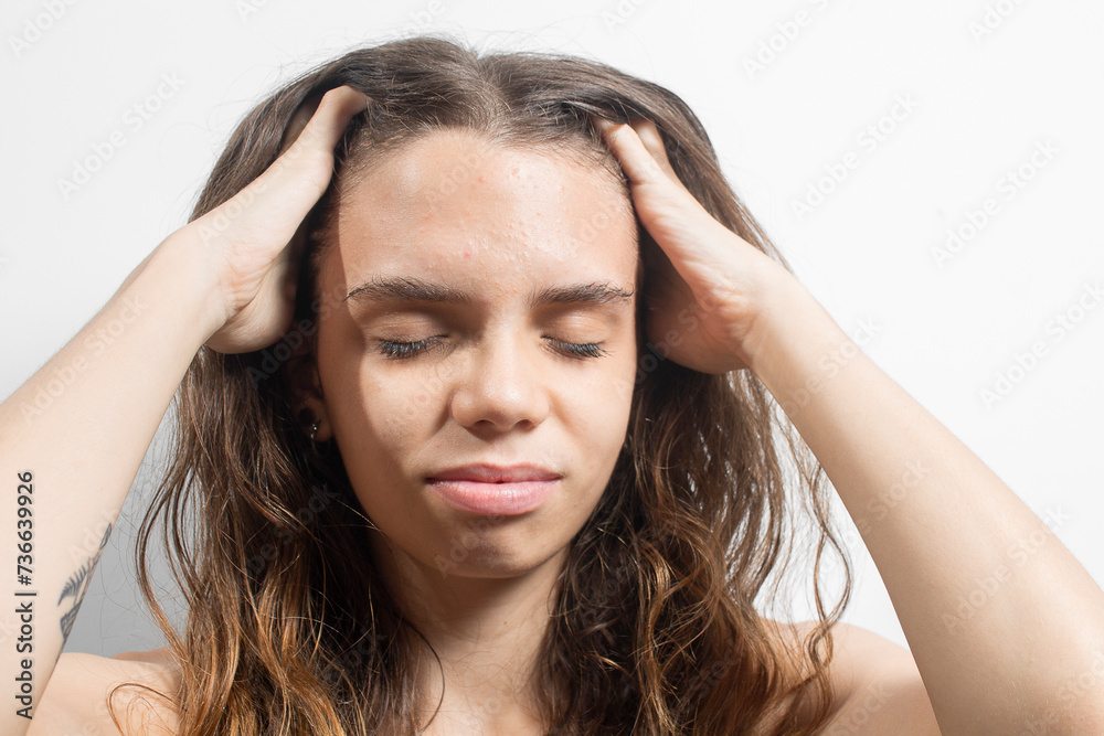 Portrait of a young blonde Latin American woman with hands on head and upset expression Portrait of a young blonde Latin American woman with hands on head and upset expression
