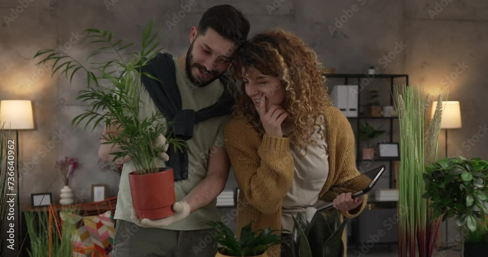 Couple man and woman wife and husband take care of plants at home Couple man and woman wife and husband take care of plants at home