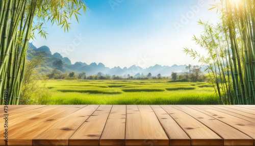 Wood table with bamboo and beautiful sunny nature background with copy space