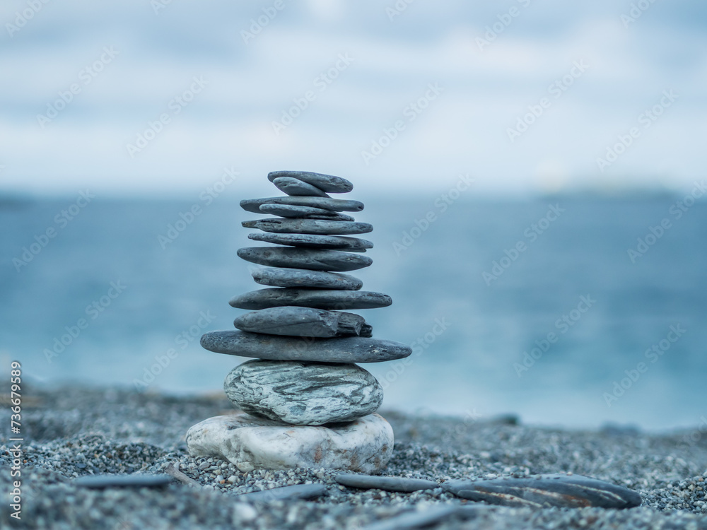 Fototapeta premium The stacking stones on the beach, representing the believe in Buddhism as in a sign of mediation.
