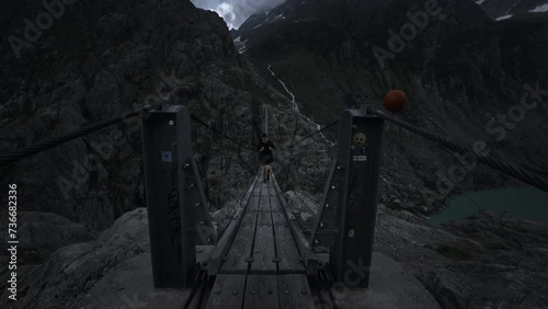 Wallpaper Mural Male hiker walking on Triftbrücke suspensions bridge in Innertkirchen Switzerland Torontodigital.ca