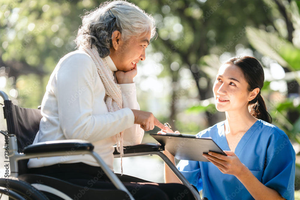 Compassionate Asian woman provides care to elderly person in wheelchair outdoors. Engaging in physical therapy, happiness, encouraging positive environment for mature individuals with grey hair. Compassionate Asian woman provides care to elderly person in wheelchair outdoors. Engaging in physical therapy, happiness, encouraging positive environment for mature individuals with grey hair.