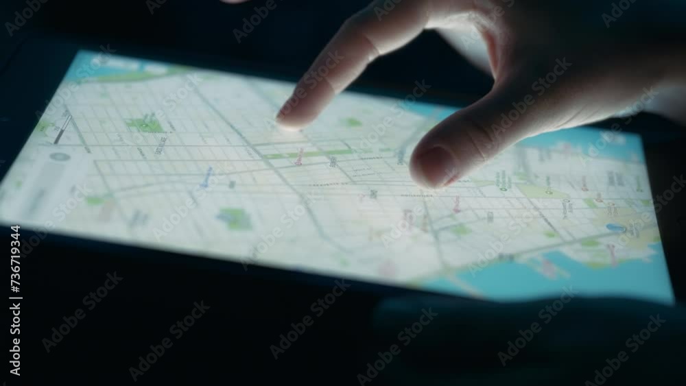 Person exploring a city map on a tablet touchscreen. Close up, slow motion. Person exploring a city map on a tablet touchscreen. Close up, slow motion.